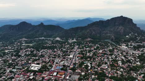 Drone-shot-overlooking-the-Tepoztlan-Magic-Town-in-Morelos,-cloudy-day-in-Mexico