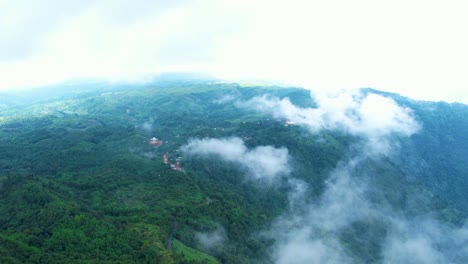 Aerial-shot-of-the-clouds-above-the-dense-rainforest-in-Meghalaya,-India