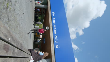 Vertical-View-Of-Passengers-Walking-Outside-The-Amsterdam-Zuid-Train-Station