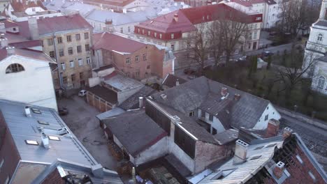Drone-shot-of-burned-house-in-Tartu-during-sunset,-after-drone-fly's-to-sun