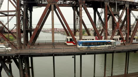 Circling-aerial-shot-over-a-Max-Tram-on-Steel-Bridge-Portland-Oregon