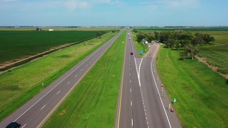 Aerial-view-flying-over-traffic-on-the-Nebraska-highway-1,-sunny,-summer-day-in-USA