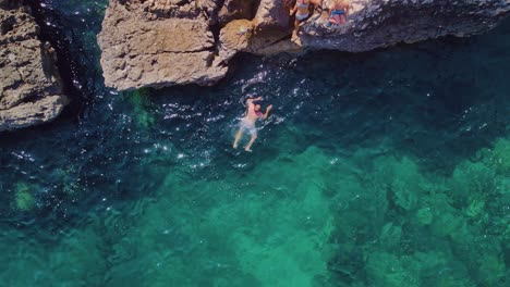 Tourists-absolutely-love-the-exhilarating-experience-of-swimming-in-the-seawater-cave-right-into-the-heart-of-the-sea-through-crystal-clear-ocean-water,-which-offers-an-incredible-view