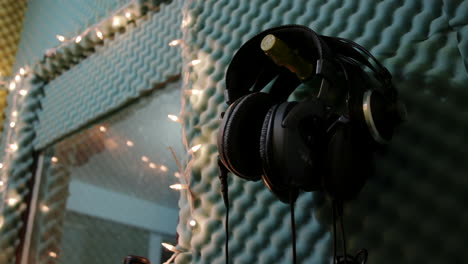 Studio-Headphones-Hanging-On-Wall-Inside-Sound-Booth