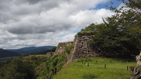 Slow-panning-shot-revealing-the-vast-landscape-and-mountain-range-at-Takeda-Castle
