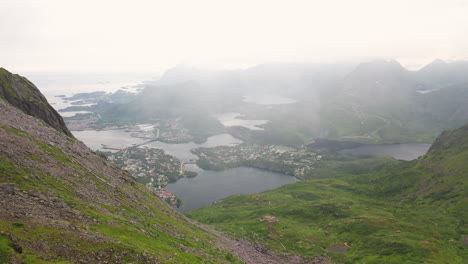 Revealing-drone-shot-of-Svolvær-in-Lofoten,-Norway-from-mountain-top,-Fløya-and-Djevelporten-aerial-footage