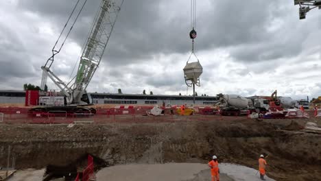 Mobile-Crane-Moving-Concrete-Bucket-At-Old-Oak-Common-Construction-Site-On-Cloudy-Day
