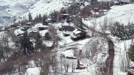 Aerial-establishing-shot-of-a-small-village-at-a-mountaintop-in-the-Farellones,-Chile