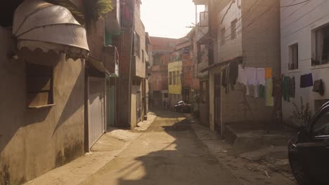 Pov-walk-in-destroyed-old-Favela-street-in-sao-Paulo-during-Sunset-time,-slow-Motion