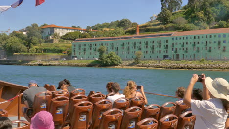 Pan-shot-of-tourists-on-a-large-boat-to-discover-the-Douro-region-in-Portugal