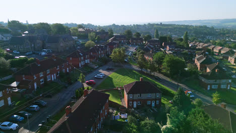 Drone-footage-reveals-Dewsbury-Moore-Council-estate,-a-UK-urban-housing-complex,-red-brick-terraces,-and-industrial-Yorkshire-on-a-sunny-summer-morning