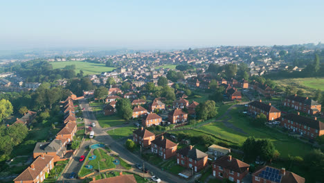 A-drone's-view-of-Dewsbury-Moore-Council-estate,-UK,-displays-red-brick-housing-and-the-industrial-Yorkshire-landscape-on-a-sunny-morning
