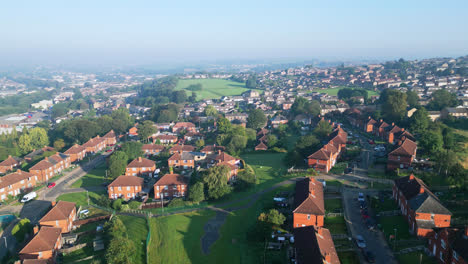 Witness-Dewsbury-Moore-Council-estate,-UK,-through-drone-captured-footage,-featuring-red-brick-housing-and-the-industrial-Yorkshire-scenery-on-a-sunny-summer-morning