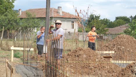 Construction-team-make-rebar-reinforcements-for-concrete-footings-trench