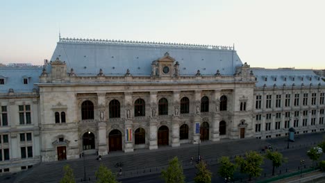 Sunset-over-the-Palace-of-Justice-and-Dambovita-River-in-Bucharest,-Romania,-Aerial-View