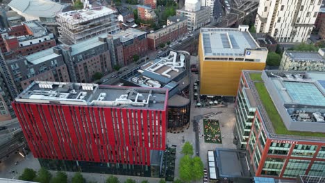 Aerial-drone-flight-over-Elizabeth-Square-with-a-slow-upward-tilt-to-reveal-Oxford-Road-and-the-surrounding-rooftops