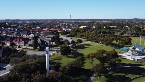 Aerial-Turn-Left-View-Towards-Modern-Lighthouse-Tower-Located-In-Park
