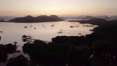 Cinematic-aerial-sunset-footage-tilting-up-to-see-the-ocean-in-Palawan,-Philippines,-Asia,-Drone