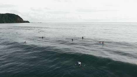 Surfers-in-calm-water,-waiting-for-waves