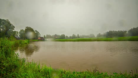 Private-lake-homestead-during-rainy-season,-time-lapse-view