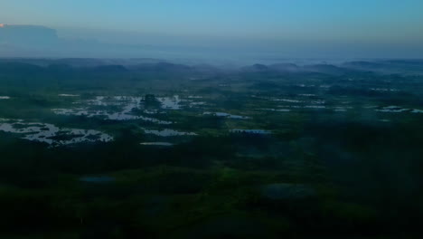 Early-morning-and-misty-landscape-of-swamps,-aerial-drone-view