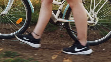 Girl-white-dress-pushes-bike-with-book-and-sunflowers-golden-hour-slow-mo