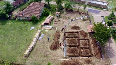 Excavation-trench-filling-by-ready-mix-concrete-boom-truck-drone-shot