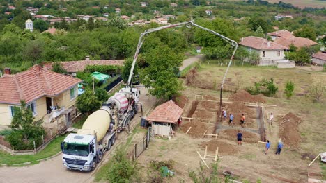 Drone-views-ready-mix-concrete-delivery-by-long-boom-to-building-plot