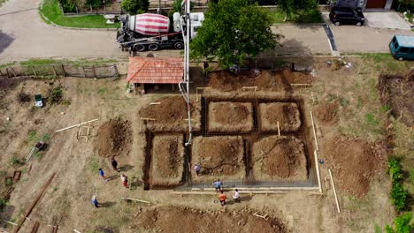 Excavated-foundations-ready-for-concrete-delivery-by-hydraulic-boom-drone-view