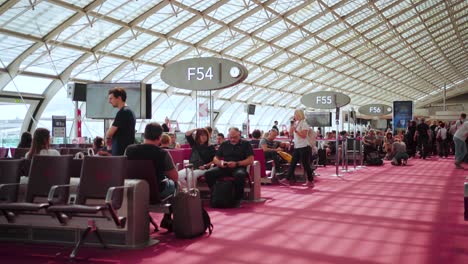 Inside-Paris-Charles-de-Gaulle-Airport:-Travelers-Waiting-at-Gates,-Pre-Flight-Activities,-Navigating-Lounges,-Duty-Free-Shops,-and-Boarding-Announcements