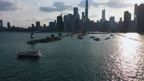 Aerial-view-flying-over-boats-driving-through-the-Chicago-Harbor-Lock,-sunny-USA