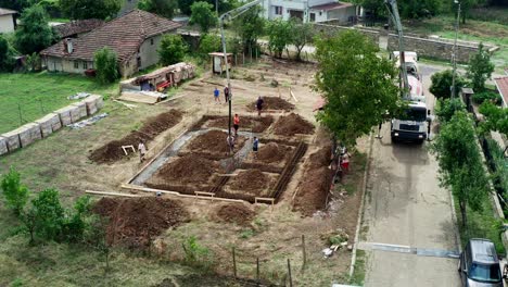 Drone-Sobre-La-Entrega-De-Concreto-Premezclado-En-El-Sitio-De-Construcción-Mediante-Un-Camión-De-Pluma-Larga