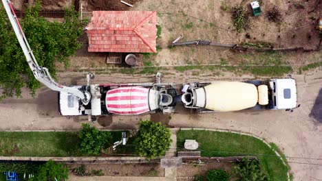 Cement-truck-deliver-ready-mix-concrete-to-building-plot-birds-eye-drone-shot