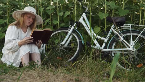 Weißes-Mädchenkleid-Mit-Fahrrad-In-Der-Sonnenblumenlandschaft-Zur-Goldenen-Stunde
