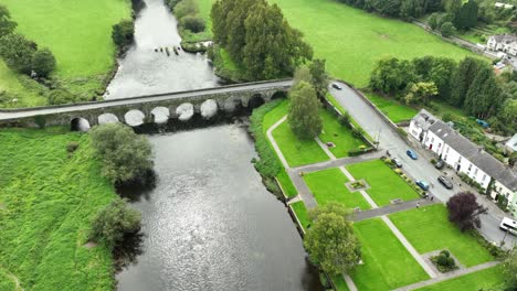 Aerial-establishing-shot-of-The-Bridge-over-The-River-Barrow-at-Inistioge-Kilkenny-ireland-Late-summer-morning