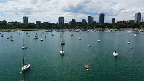 Aerial-view-low-over-moored-sailboats-at-the-coast-of-Millwaukee,-summer-day-in-USA