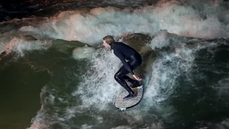 Cinematic-slow-motion-Eisbach-Wave-River-Surfer-community-Munich-Germany-over-bridge-below-fall-autumn-beautiful-night-surfing-high-flow-water-surf-Upper-Bavaria-Alps-flow-follow-movement