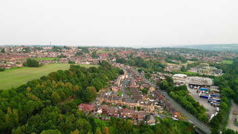 Dewsbury-Moore-Council-estate's-fame-shines-in-this-drone-captured-video,-showcasing-the-classic-urban-housing,-red-brick-terraced-homes,-and-the-scenic-Yorkshire-landscape-during-a-summer-evening