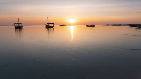 Dhow-boats-at-sunset,-Zanzibar-in-Tanzania