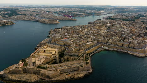 Drone-overview-of-the-Valletta-cityscape,-overcast,-summer-evening-in-Malta
