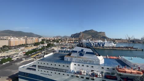 Cruise-vessels-docked-in-the-port-of-Palermo,-Italy,-in-the-background-of-the-skyline