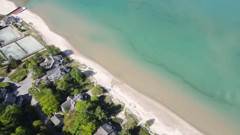 Lake-Michigan-shoreline-with-private-estates-in-Glen-Arbor-town,-aerial-view