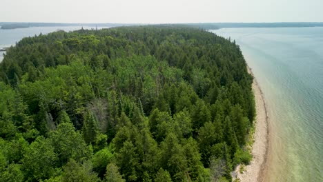 Aerial-view-over-forested-island,-Lake-Huron,-Michigan