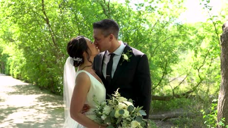 Gorgeous-brunette-couple-posing-on-their-wedding-day-outside