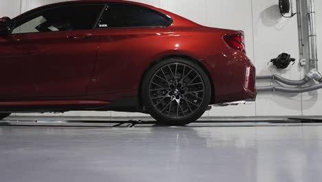 A-close-up-zoomed-in-shot-captures-the-intricate-details-of-a-BMW-tire-as-it-undergoes-meticulous-inspection-in-an-automotive-garage