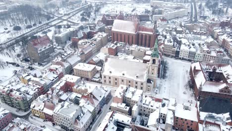 Scenic-aerial-view-on-old-town-in-Torun,-Poland-covered-with-snow-on-winter-day