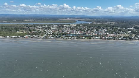 Aerial-drone-shot-flying-towards-Beachmere-Town-and-Caboolture-River,-shot-at-mid-day
