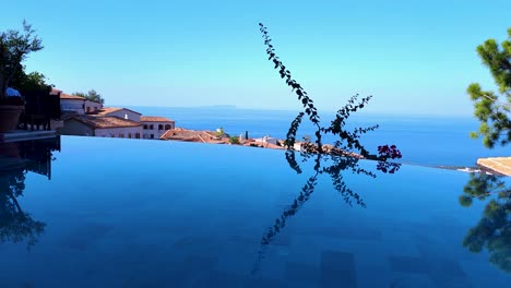 Infinity-pool-on-luxury-resort-located-on-mountain-village-overlooking-the-Ionian-sea-in-Albania,-beautiful-summer-vacation-in-Mediterranean