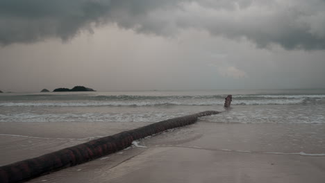Koh-Chang,-Thailand,-a-tranquil,-overcast-day,-the-camera-captures-the-rhythmic-dance-of-ocean-waves-rolling-onto-a-picturesque-beach