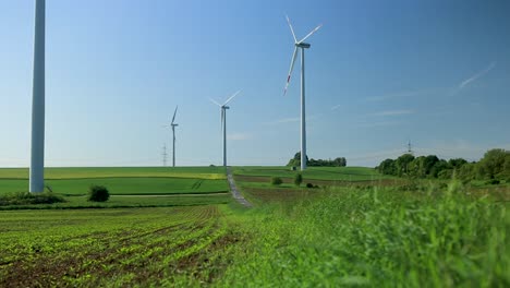 Non-moving,-still-standing-wind-turbines,-beautiful-green-field-in-rural-Germany